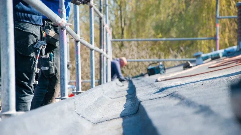 Commercial roof inspections being performed during roof repair work on a commercial building