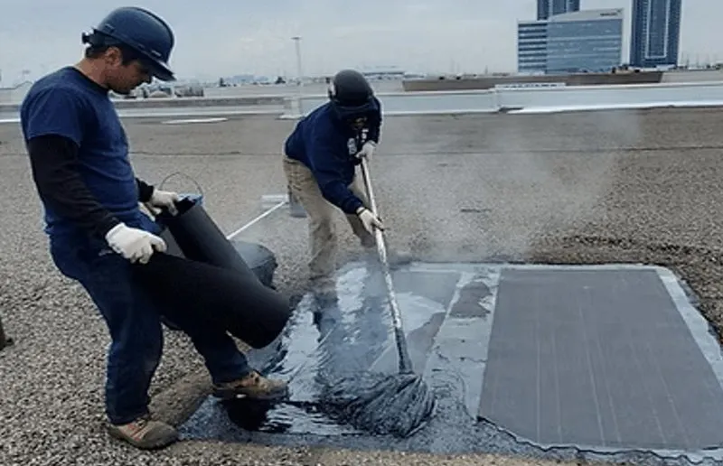 a pair of roof maintenance men fixing a roof