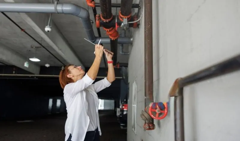 a woman inspecting leaks. emergency roofing